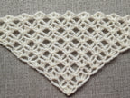 Detailed view of finished edge and lace stitch pattern on a triangle crochet bandana shawl, Chart 2.
