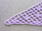 Detailed view of finished edge and lace stitch pattern on a triangle crochet bandana shawl, Chart 3.