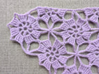 Detailed view of finished edge and lace stitch pattern on a triangle crochet bandana shawl, Chart 4.