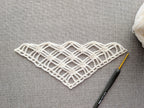 Detailed view of finished edge and lace stitch pattern on a triangle crochet bandana shawl, Chart 6.