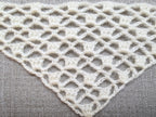Detailed view of finished edge and lace stitch pattern on a triangle crochet bandana shawl, Chart 7.