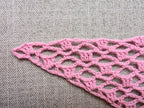 Detailed view of finished edge and lace stitch pattern on a triangle crochet bandana shawl, Chart 7.