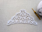Detailed view of finished edge and lace stitch pattern on a triangle crochet bandana shawl, Chart 10.