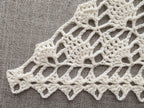 Detailed view of finished edge and lace stitch pattern on a triangle crochet bandana shawl, Chart 11.