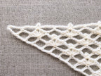 Detailed view of finished edge and lace stitch pattern on a triangle crochet bandana shawl, Chart 13.