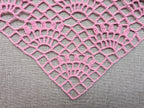 Close-up shot of intricate lace stitches and openwork mesh texture on a crochet bandana shawl.