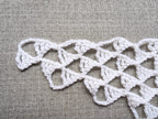 Close-up shot of intricate stitches and textured design on a crochet Baktus scarf.
