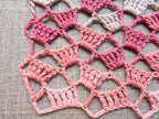 Detailed view of finished edge and lace stitch pattern on a crochet scarf, Chart 21.