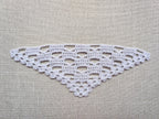 Detailed view of finished edge and lace stitch pattern on a triangle crochet bandana shawl, Chart 27.