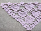 Detailed view of finished edge and lace stitch pattern on a triangle crochet bandana shawl, Chart 28.