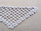 Detailed view of finished edge and lace stitch pattern on a triangle crochet bandana shawl, Chart 29.