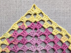 Detailed view of finished edge and lace stitch pattern on a triangle crochet bandana shawl, Chart 31.