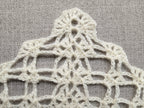 Detailed view of finished edge and lace stitch pattern on a triangle crochet bandana shawl, Chart 33.