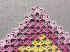Detailed view of finished edge and lace stitch pattern on a triangle crochet bandana shawl, Chart 34.
