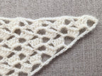 Detailed view of finished edge and lace stitch pattern on a triangle crochet bandana shawl, Chart 35.