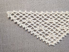 Detailed view of finished edge and lace stitch pattern on a triangle crochet bandana shawl, Chart 37.