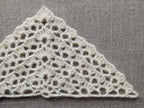 Detailed view of finished edge and lace stitch pattern on a triangle crochet bandana shawl, Chart 38.