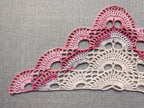 Detailed view of finished edge and lace stitch pattern on a triangle crochet bandana shawl, Chart 39.