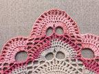 Close-up shot of intricate lace stitches and openwork mesh texture on a crochet bandana shawl.