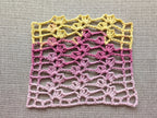 Detailed view of finished edge and lace stitch pattern on a crochet scarf, Chart 40.