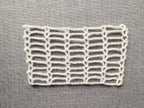 Detailed view of finished edge and lace stitch pattern on a crochet scarf, Chart 41.