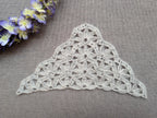 Detailed view of finished edge and lace stitch pattern on a triangle crochet shawl, Chart 47.