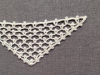 Detailed view of finished edge and lace stitch pattern on a triangle crochet bandana shawl, Chart 50.