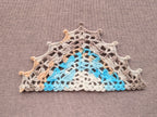 Detailed view of finished edge and lace stitch pattern on a triangle crochet bandana shawl, Chart 52.