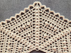 Detailed view of finished edge and lace stitch pattern on a triangle crochet shawl, Chart 57.
