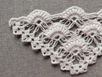 Detailed view of finished edge and lace stitch pattern on a triangle crochet shawl, Chart 58.