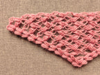 Detailed view of finished edge and lace stitch pattern on a triangle baktus crochet shawl, Chart 59.