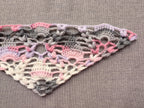 Detailed view of finished edge and lace stitch pattern on a triangle crochet shawl, Chart 60.