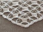 Detailed view of finished edge and lace stitch pattern on a triangle crochet bandana shawl, Chart 62.