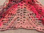 Detailed view of finished edge and lace stitch pattern on a triangle crochet bandana shawl, Chart 64.