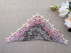 Detailed view of finished edge and lace stitch pattern on a triangle crochet shawl, Chart 69.