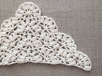 Detailed view of finished edge and lace stitch pattern on a triangle crochet bandana shawl, Chart 74.