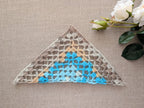 Detailed view of finished edge and lace stitch pattern on a triangle crochet bandana shawl, Chart 76.