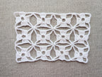 Detailed view of seamless motif joins and finished edging on a crochet shawl, Chart 80.