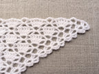 Detailed view of finished edging and lace stitch pattern on a triangle crochet baktus, Chart 88.