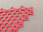 Detailed view of decorative custom border edging on a handmade lace triangle crochet shawl.