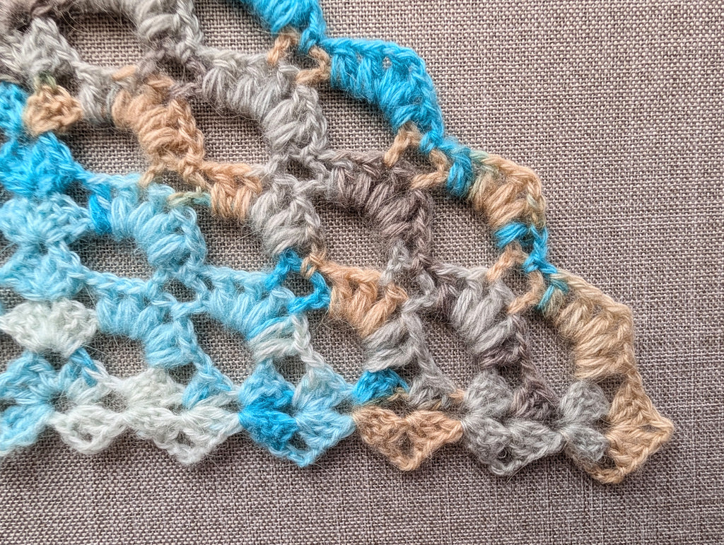 Crochet stitch key and symbol chart 107 for intermediate winter triangle scarf PDF pattern, featuring vector symbol definitions and abbreviations.