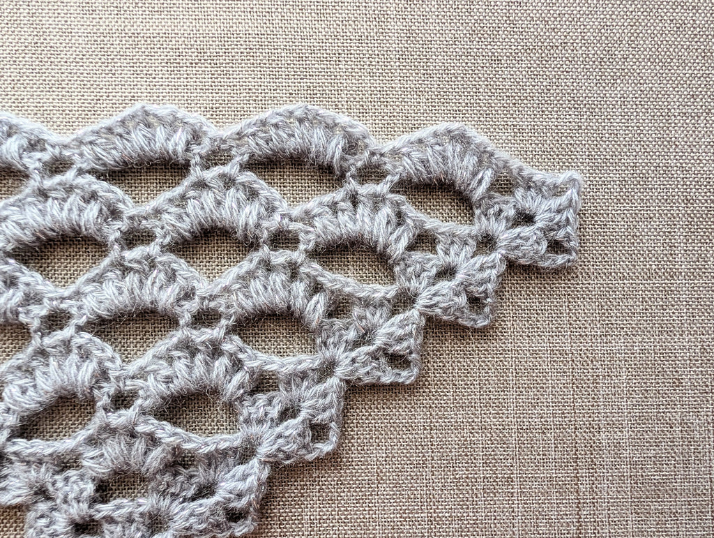 Stitch symbol reference guide for Chart 107 in the winter shawl wrap crochet pattern.