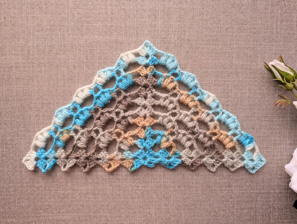 Chart 107 crochet stitch symbol key and legend for the romantic winter puff stitch triangle shawl pattern, showing chain, slip stitch, double crochet, and 2 and 3 hdc clusters in US terms.