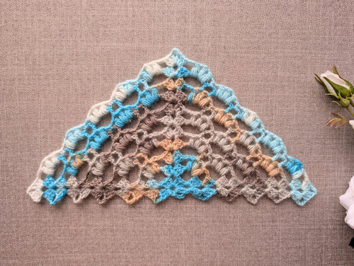 Chart 107 crochet stitch symbol key and legend for the romantic winter puff stitch triangle shawl pattern, showing chain, slip stitch, double crochet, and 2 and 3 hdc clusters in US terms.