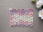 Crochet Chart 101 lacy wrap laid flat showing continuous color transitions in gradient cake yarn.