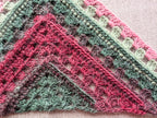 Model wearing Chart 113 large statement crochet shawl showcasing 4/6-row repeat pattern expansion.