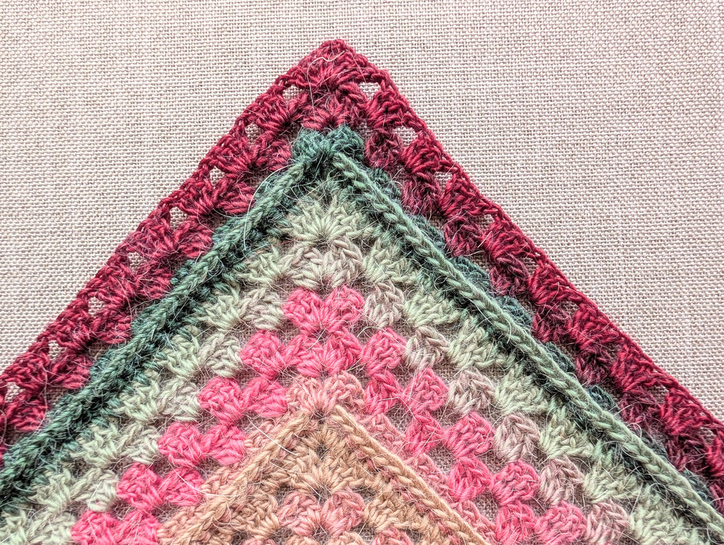 Model wearing Chart 113 large statement crochet shawl showcasing 4/6-row repeat pattern expansion.