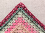 Model wearing Chart 113 large statement crochet shawl showcasing 4/6-row repeat pattern expansion.