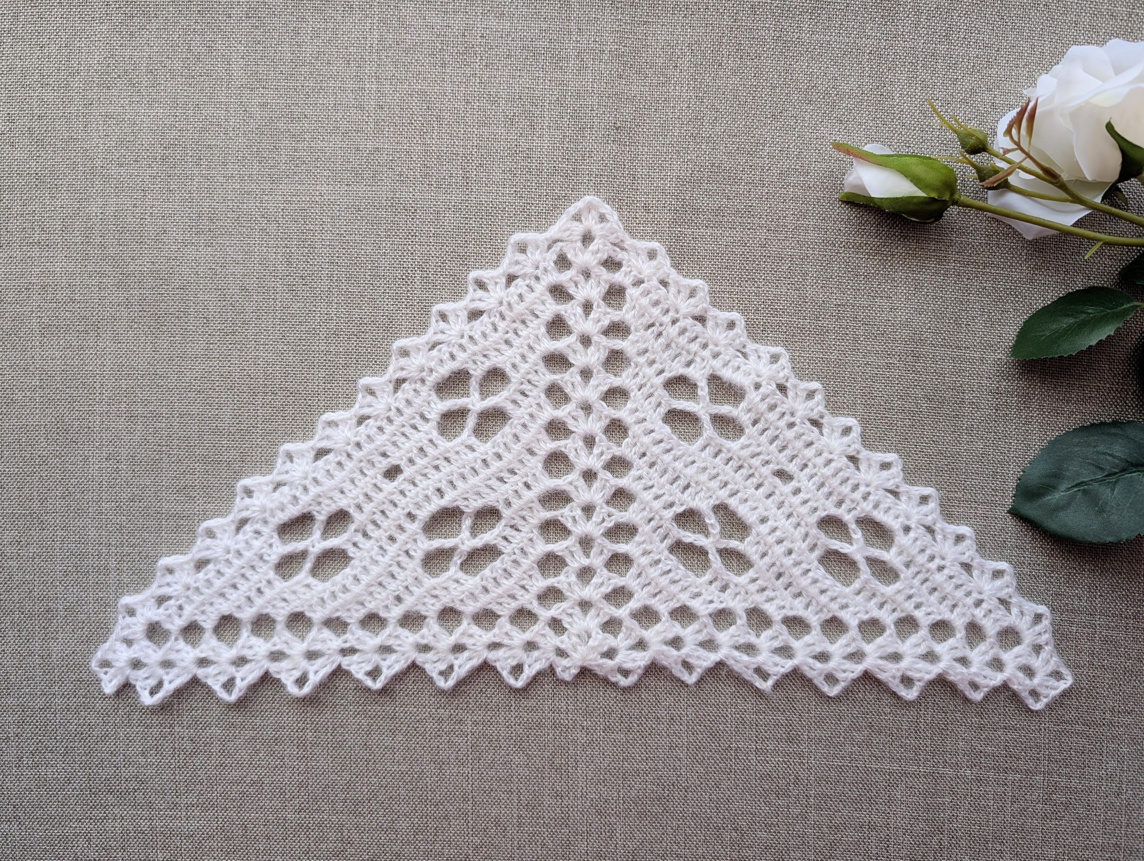 Handmade filet crochet lace bandana shawl featuring delicate floral motifs and a decorative shell border, Pattern #104.