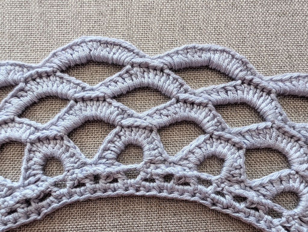The completed Chart 117 handmade crochet lace collar laid gracefully.